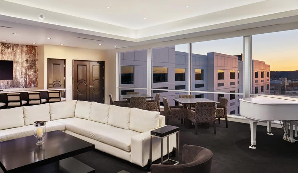 Presidential Suite Living Space | Couch and Piano | Davenport Grand