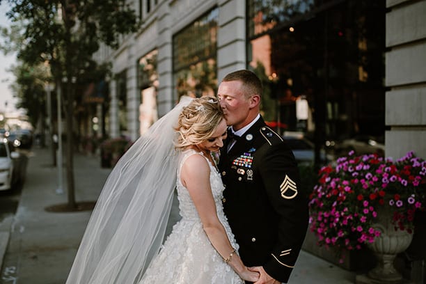 Bride and Groom Kissing in front of Hotel