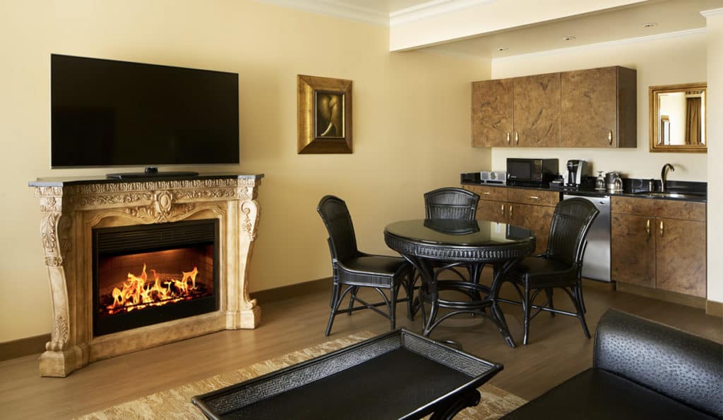 Davenport Tower Suite living area | Kitchen and table and fireplace