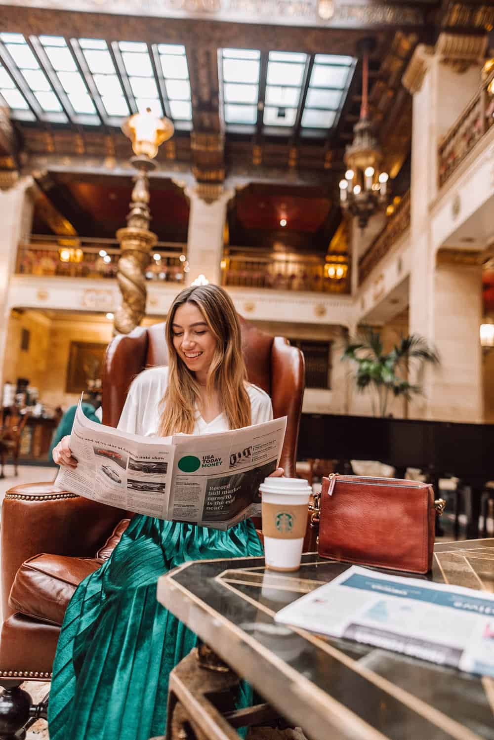 Women in lobby reading newspaper | Historic Davenport